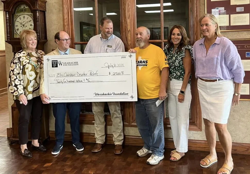 Six representatives hold a $2,500 Waxahachie Foundation check presented to Ellis Christian Disaster Relief.