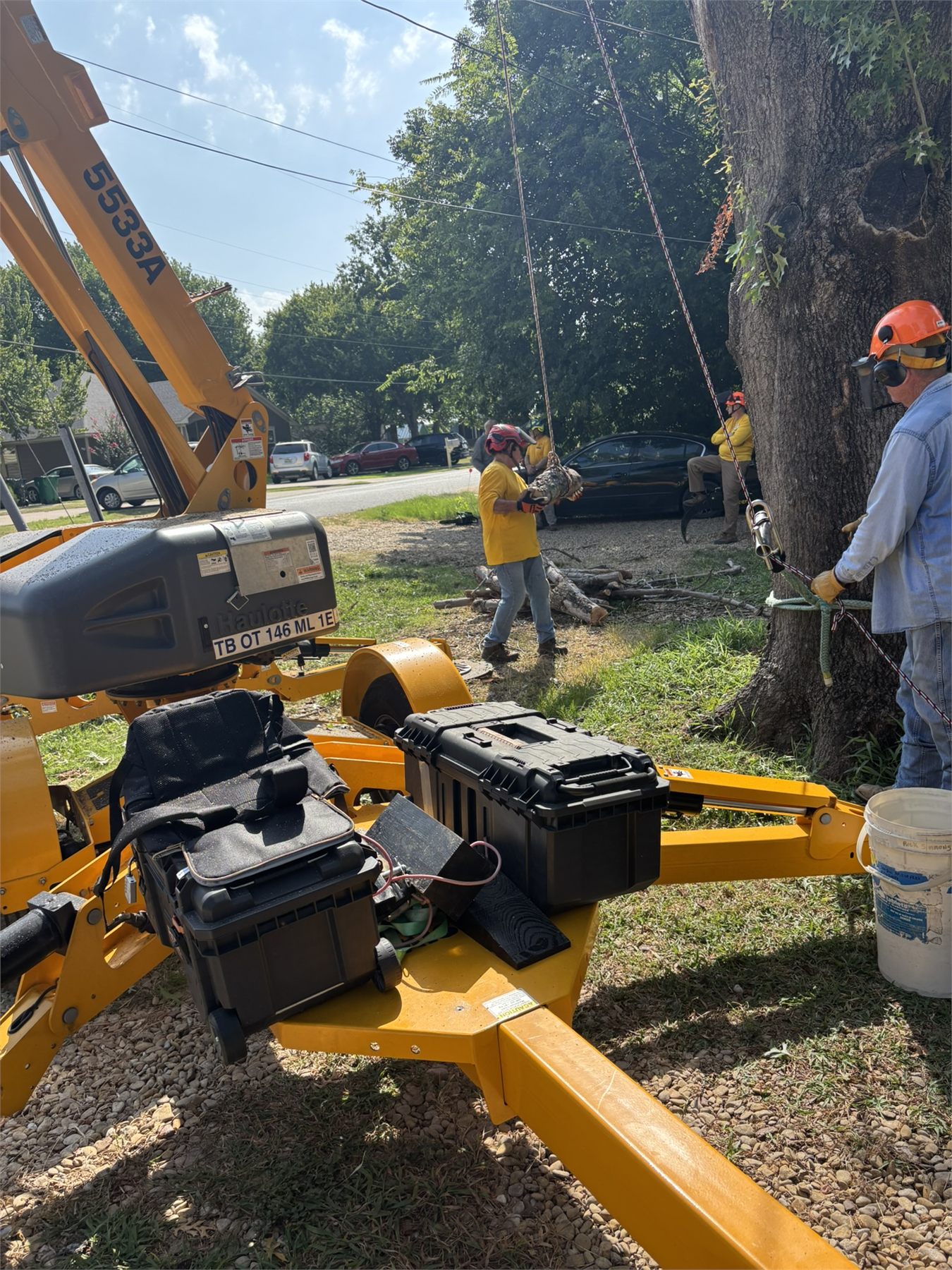 Chainsaw ministry volunteers prepare rigging and lift equipment beside a large tree in Waxahachie.