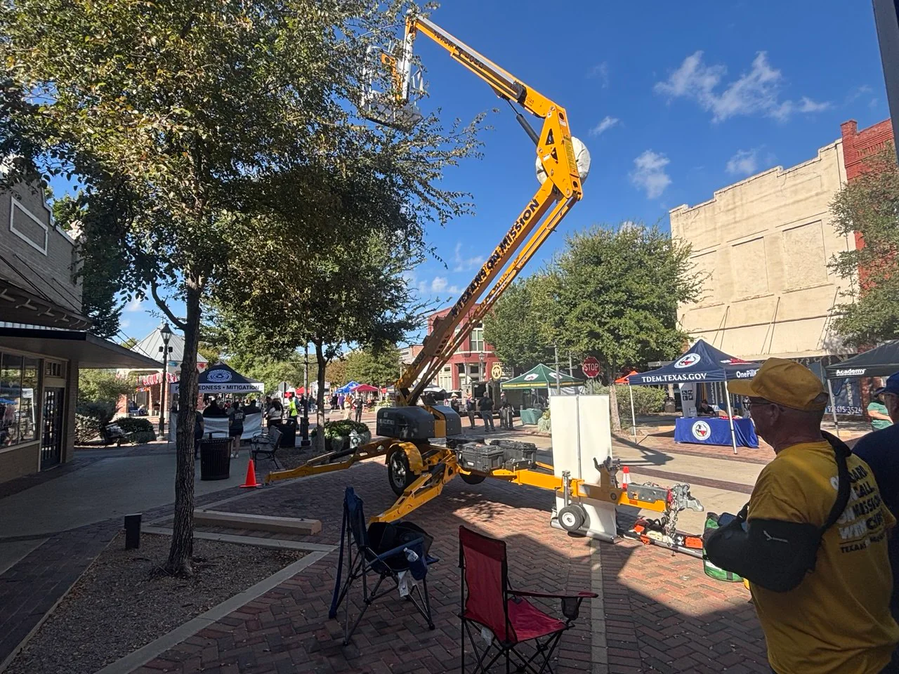 ECDR bucket lift raised above emergency preparedness booths during the Ellis County Preparedness Fair.