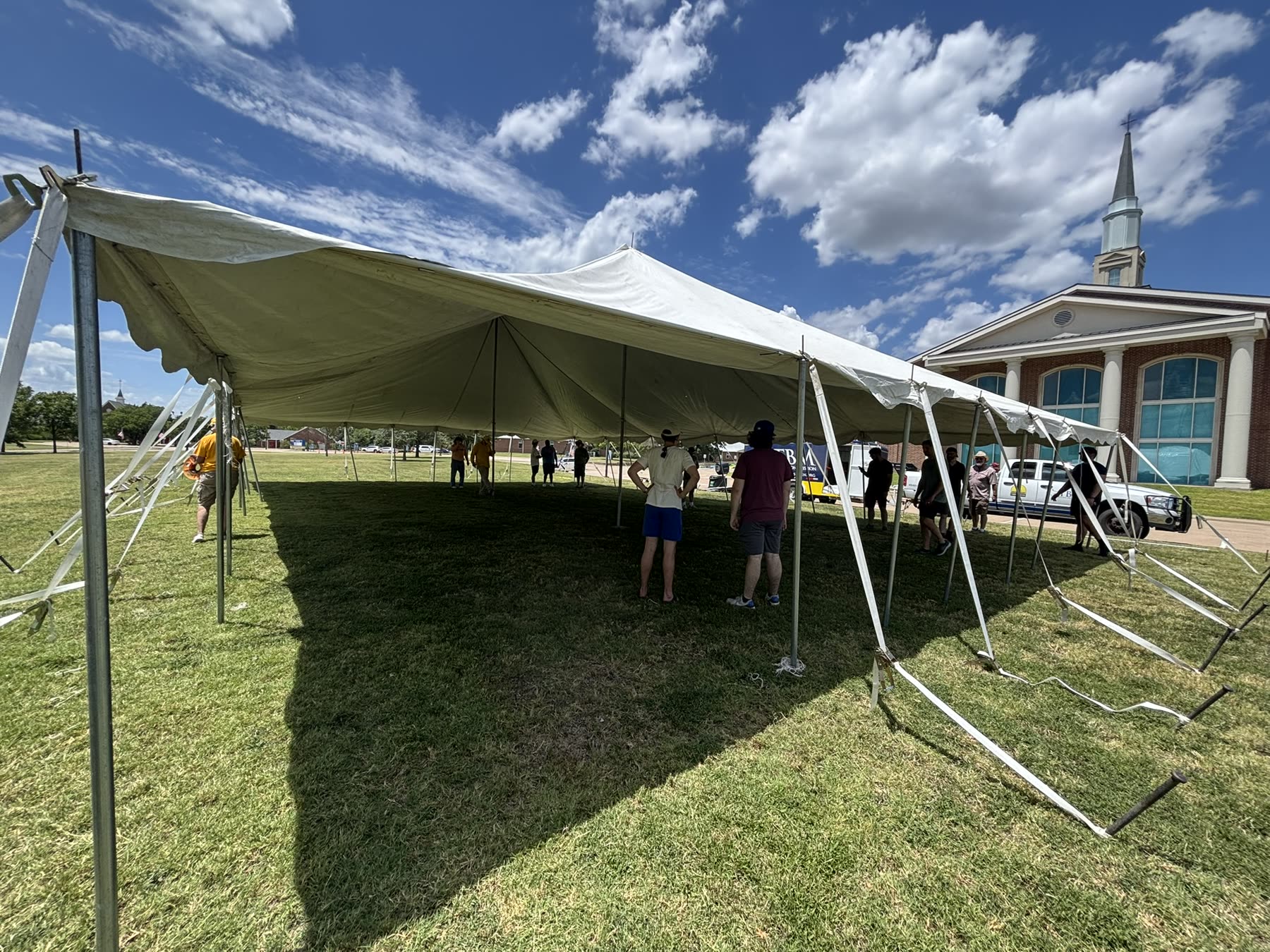 Volunteers and guests gathered under the ECDR tent at Hillcrest Baptist Church.