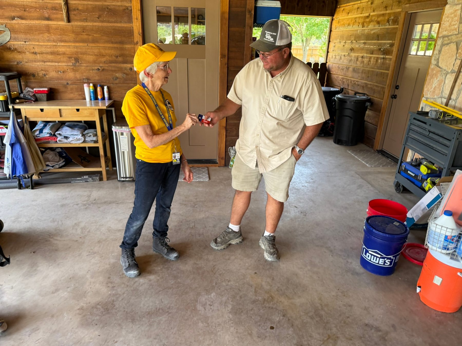 Texans On Mission volunteer shares encouragement with a Kerrville resident after flood recovery work.