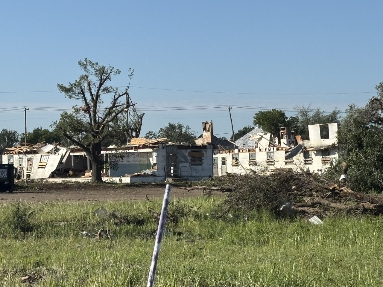 Storm-damaged buildings and tree debris at the Mineral Wells Texans On Mission deployment.