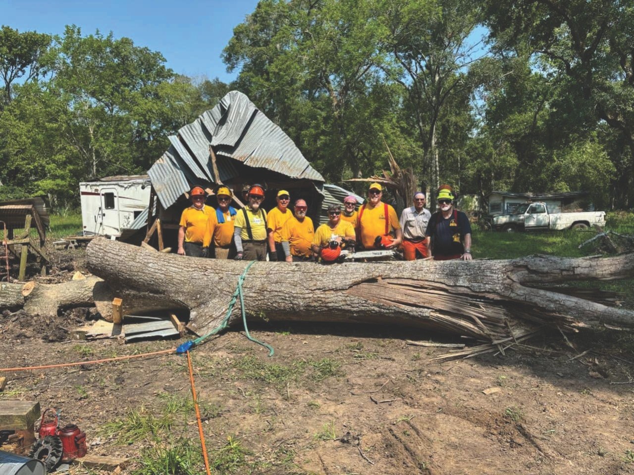 ECDR chainsaw volunteers standing together after storm cleanup work.