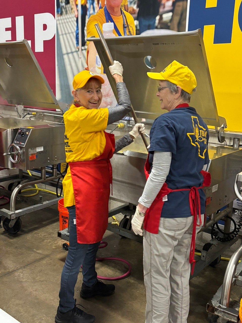 Disaster relief volunteers serving together in a feeding ministry kitchen.